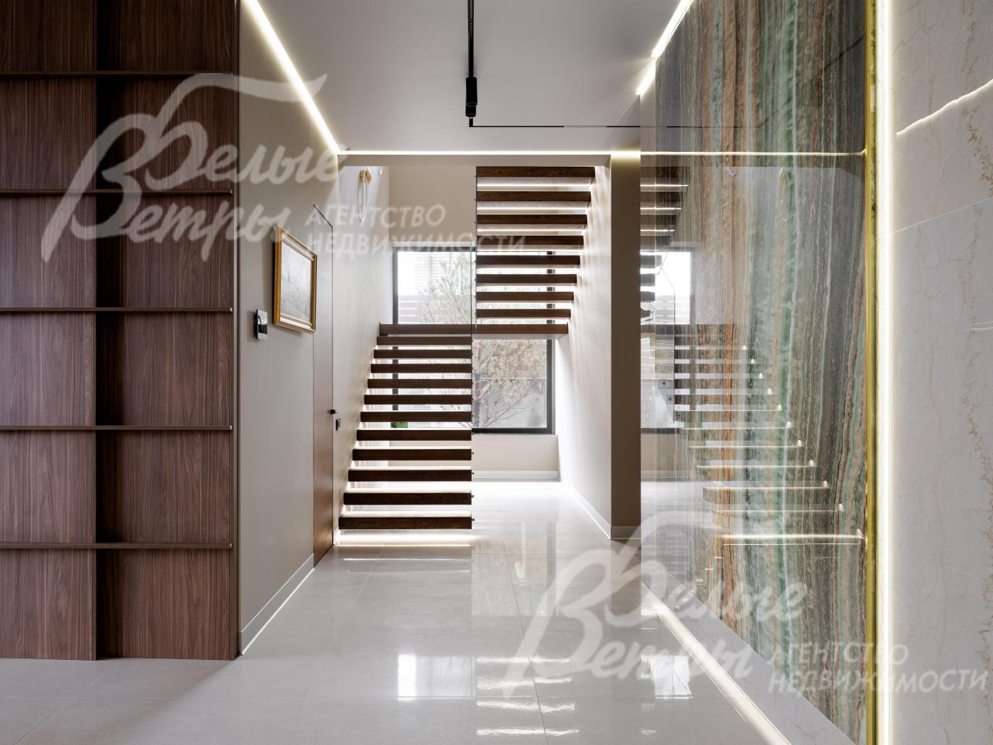 На второй этаж ведёт «парящая» лестница с подсветкой в основании, ступенями из шпона дуба и стеклянным ограждением