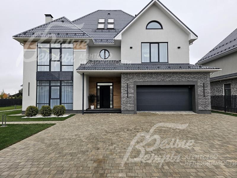 У гаража - парковка на 4 автомобиля, выложена брусчаткой на бетонном основании