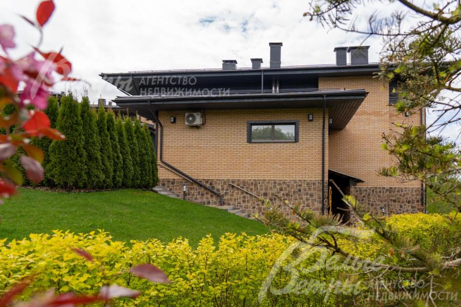 Дом гармонично вписанный в склон, цоколь дома облицован цементной декоративной плиткой