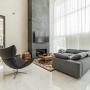 В гостиной находится мебель BoConcept: большой диван, кресло, журнальный столик