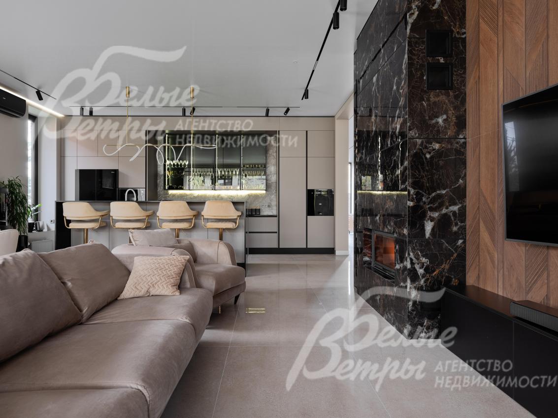 Единое функциональное пространство гостиной и кухни, зонированное островом